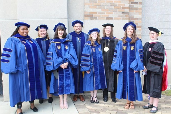 English Graduate Students At Commencement With Faculty Members