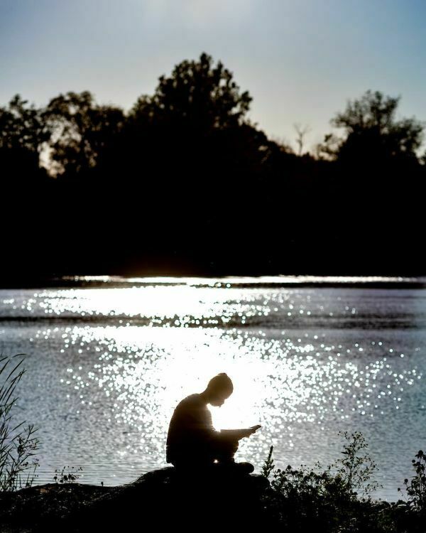 Student Reading By The Saint Marys Lake