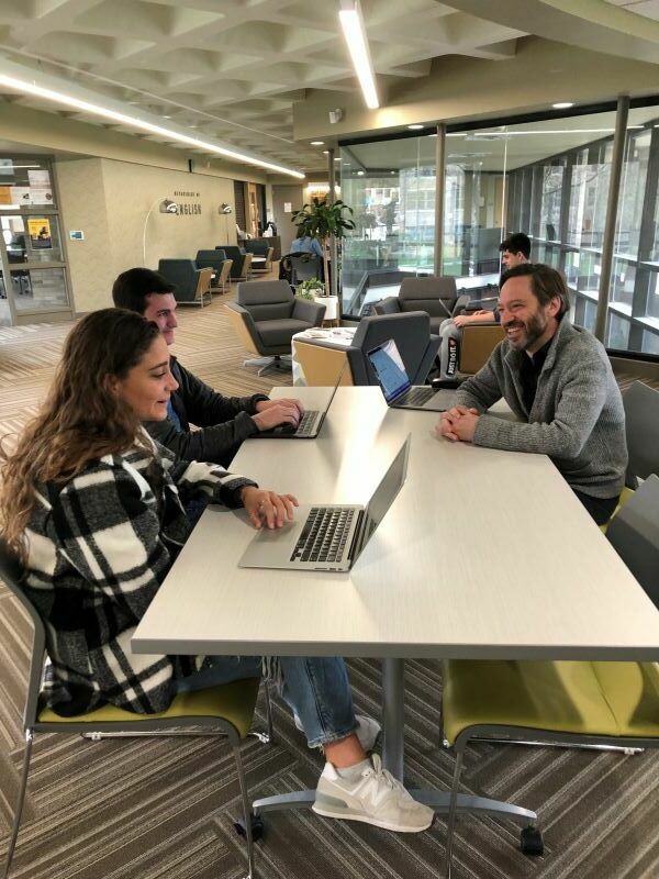 Students And A Faculty Member Chat In The English Department Commons
